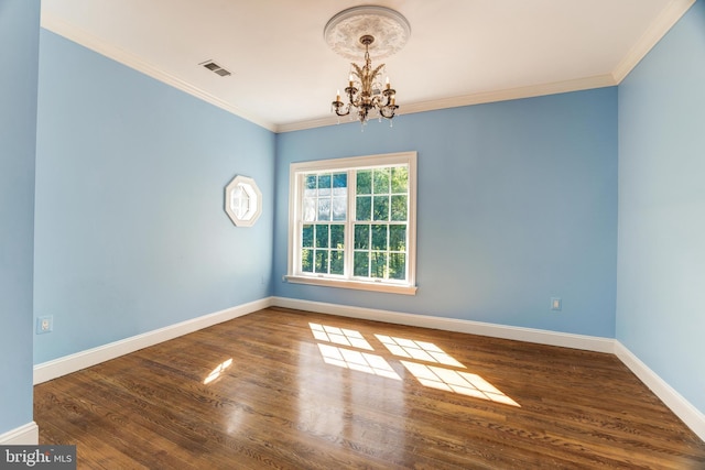 empty room with an inviting chandelier, dark hardwood / wood-style flooring, and crown molding