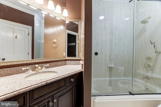 bathroom featuring shower / bath combination with glass door, vanity, and crown molding