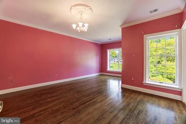 unfurnished room featuring dark wood-type flooring, ornamental molding, and an inviting chandelier