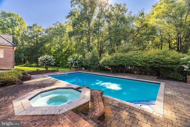 view of swimming pool featuring an in ground hot tub