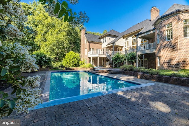 view of swimming pool featuring a patio area