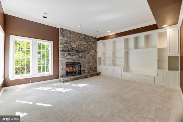 unfurnished living room featuring a fireplace, ornamental molding, and carpet flooring