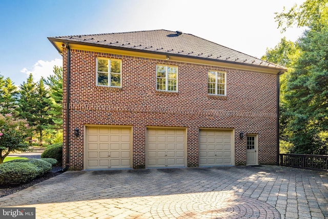 view of side of property with a garage