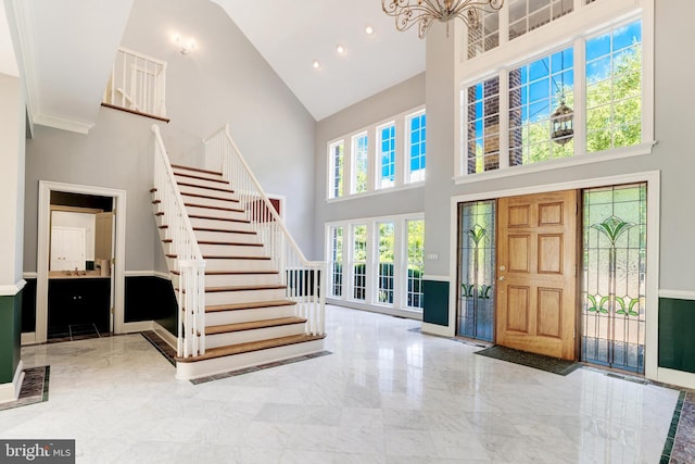 foyer with a high ceiling and a chandelier