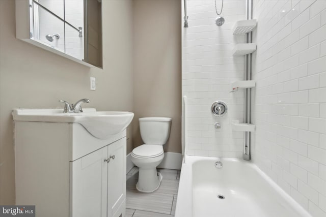 full bathroom featuring tiled shower / bath, vanity, and toilet