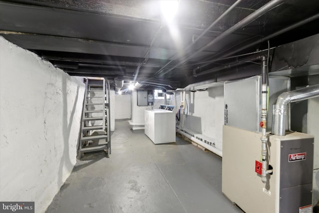 basement with electric panel, heating unit, and washer and dryer