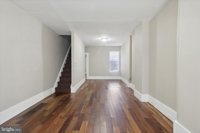 basement with dark hardwood / wood-style flooring