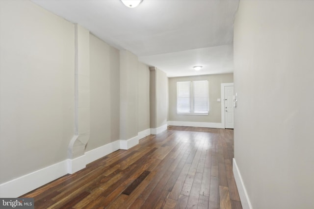 unfurnished room with dark hardwood / wood-style floors