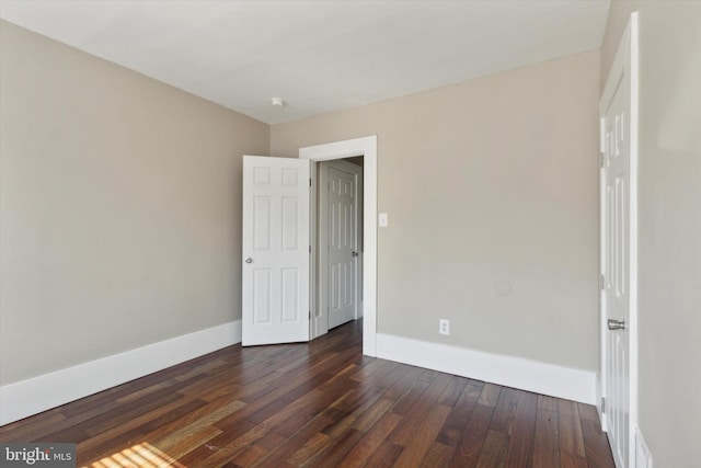 unfurnished bedroom with dark wood-type flooring