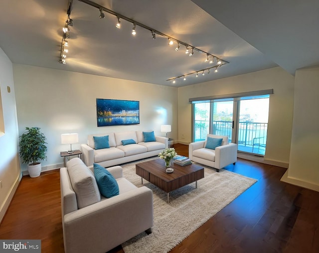 living room with dark wood-style flooring and baseboards