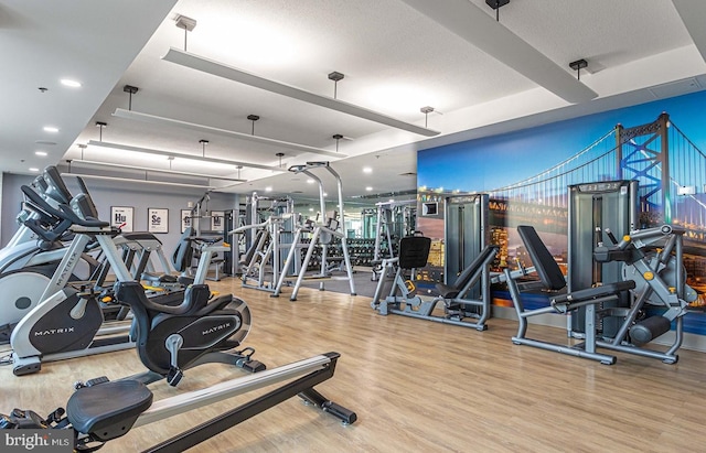 workout area featuring hardwood / wood-style floors and a textured ceiling