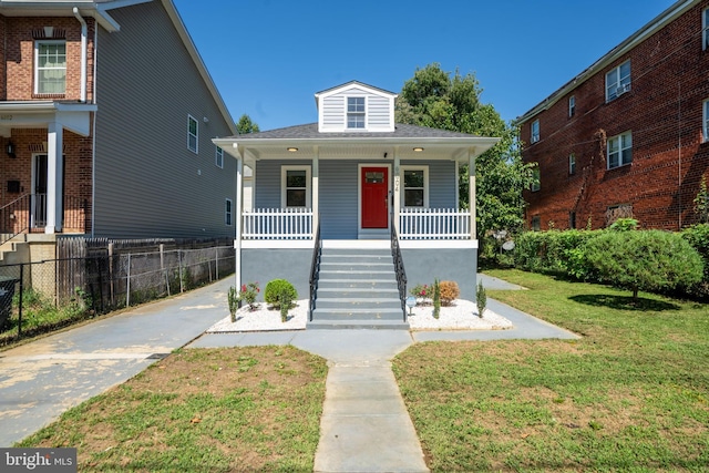 bungalow featuring a front lawn and covered porch