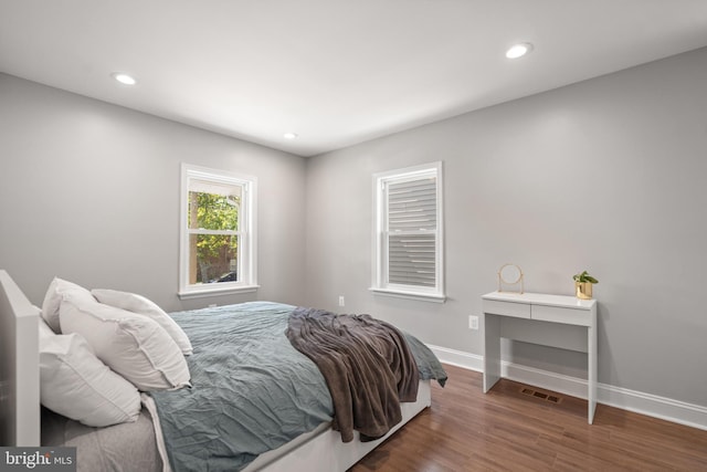 bedroom with dark wood-type flooring