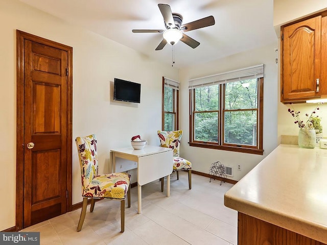 home office with ceiling fan, visible vents, and baseboards