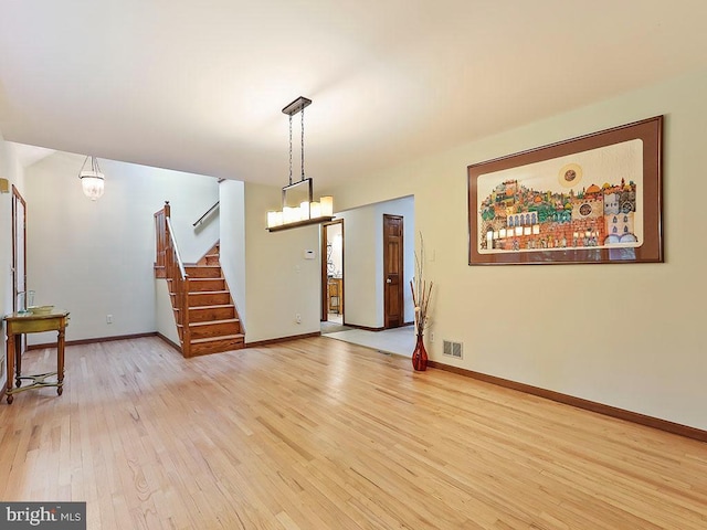 dining room with an inviting chandelier and light hardwood / wood-style flooring