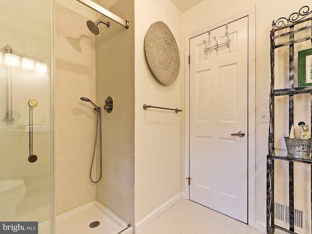 bathroom with tile patterned floors and a shower with shower door