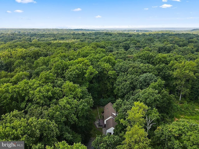 drone / aerial view featuring a wooded view