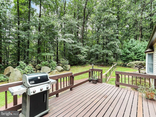 deck featuring a lawn and a grill