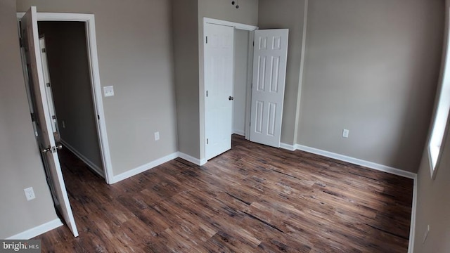 unfurnished bedroom featuring dark hardwood / wood-style flooring