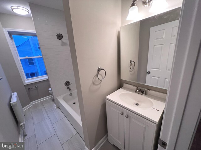 full bathroom featuring radiator, tub / shower combination, toilet, tile patterned floors, and vanity