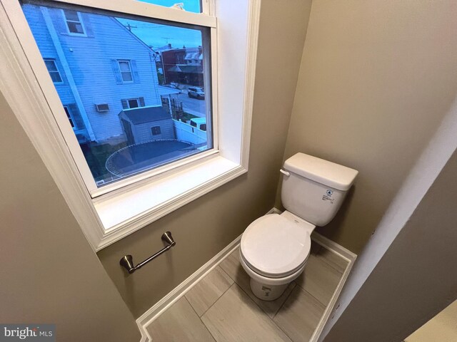 full bathroom with bathtub / shower combination, toilet, vanity, and tile patterned flooring