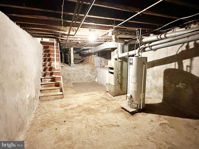 basement featuring washing machine and clothes dryer and gas water heater