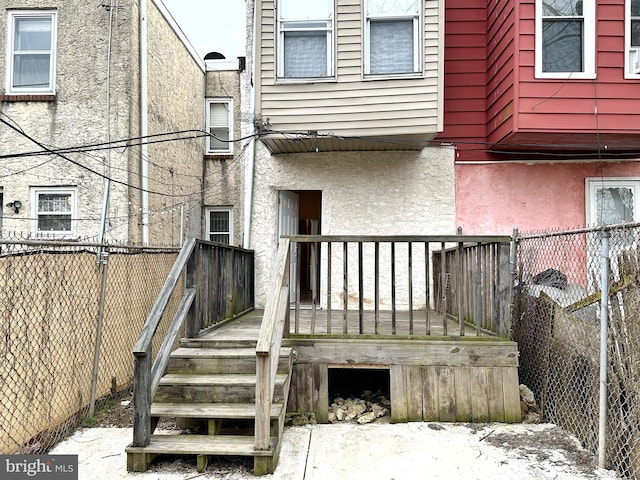 back of house featuring a wooden deck