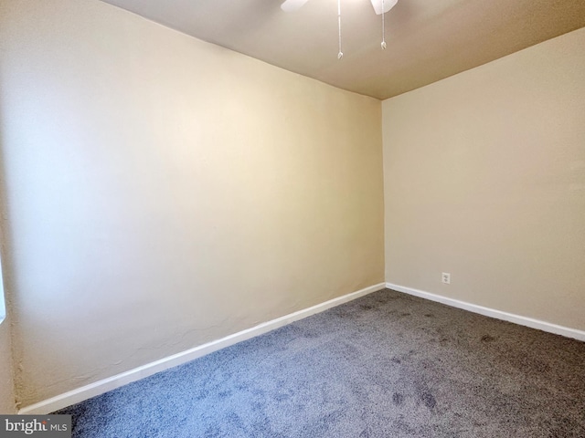 unfurnished room with ceiling fan and carpet