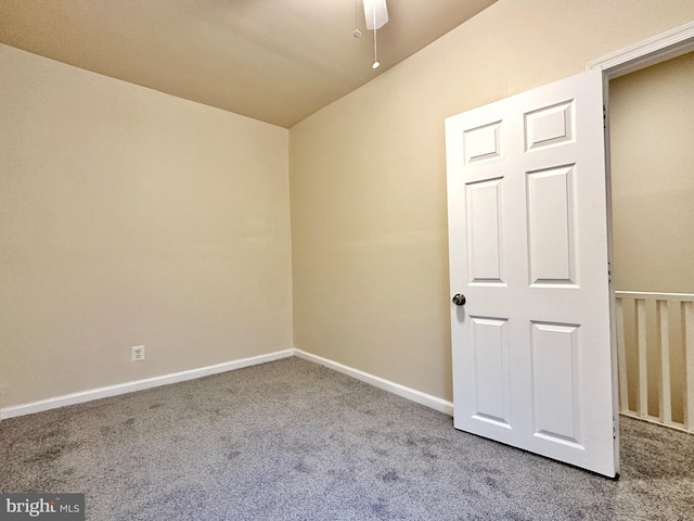 empty room with ceiling fan and carpet flooring