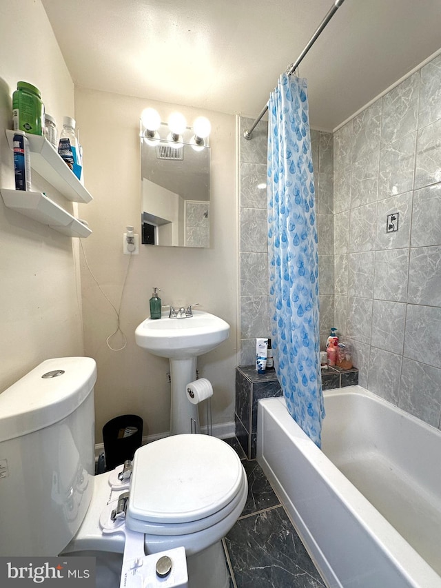 bathroom featuring shower / bath combo, toilet, and tile patterned floors