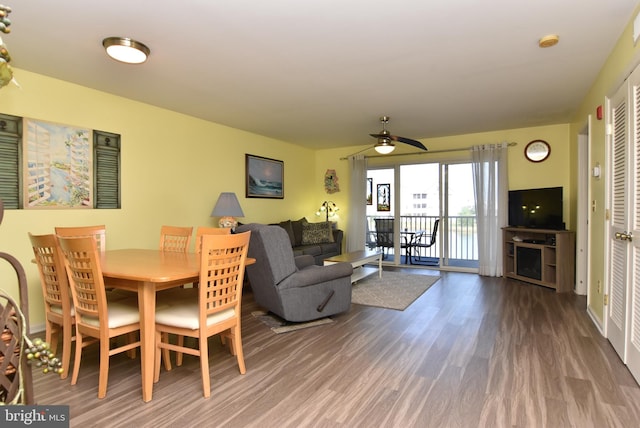 dining space featuring ceiling fan and wood-type flooring