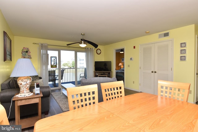 dining area with hardwood / wood-style flooring and ceiling fan