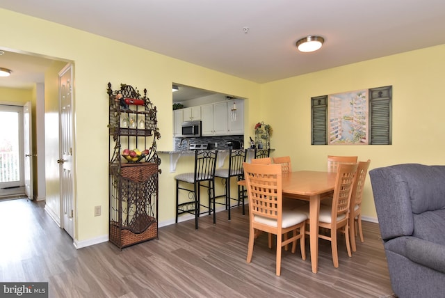 dining space with dark hardwood / wood-style flooring