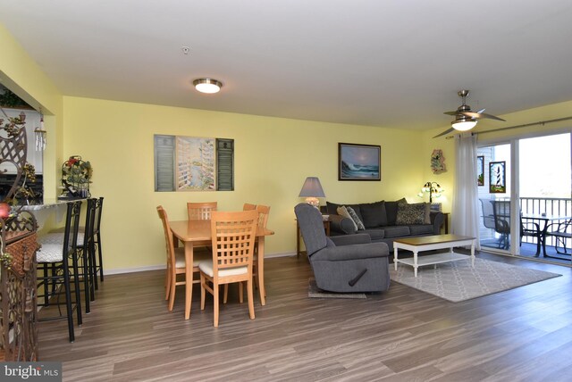 dining area featuring ceiling fan and dark hardwood / wood-style floors