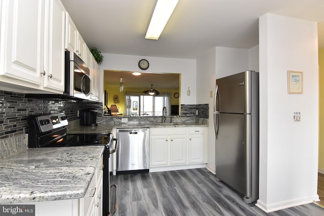 kitchen with dark hardwood / wood-style floors, sink, appliances with stainless steel finishes, and white cabinets