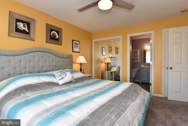 carpeted bedroom featuring a closet, ceiling fan, and ensuite bathroom