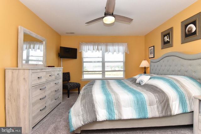 bedroom with carpet flooring, multiple windows, and ceiling fan