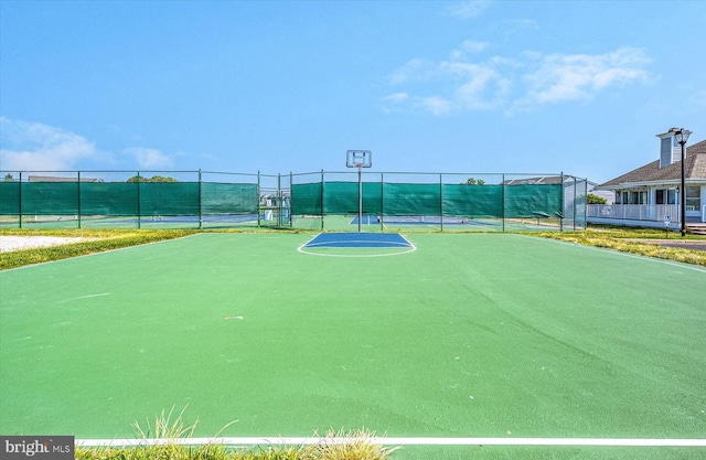 surrounding community with tennis court and basketball hoop