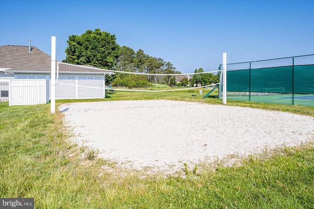 view of community with a lawn and volleyball court