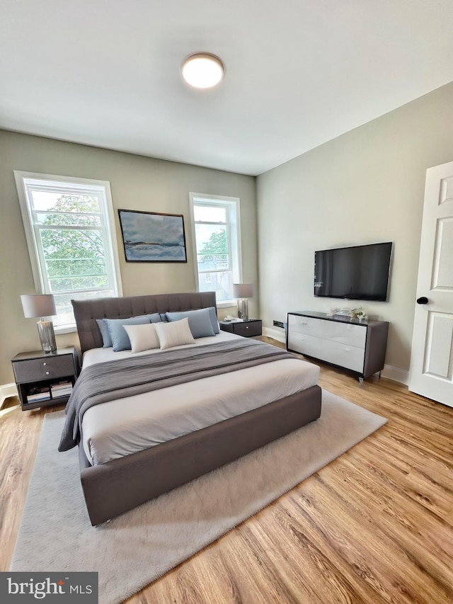 bedroom with baseboards and light wood-style floors