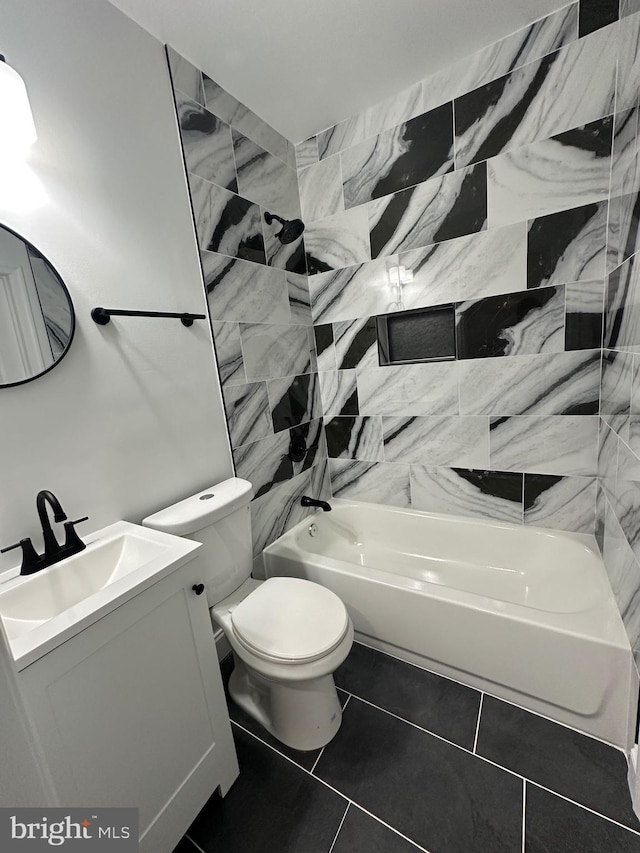 full bathroom featuring toilet, tile patterned floors, vanity, and bathing tub / shower combination