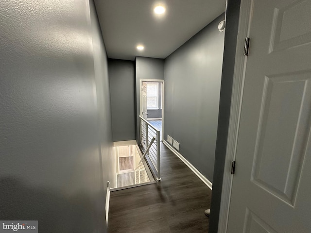 corridor featuring dark wood-type flooring