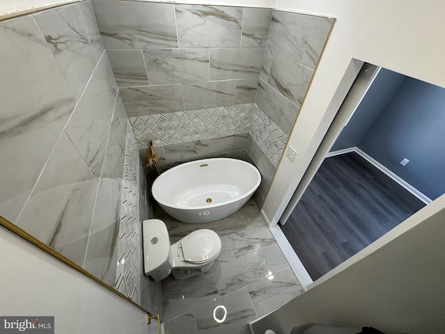 bathroom featuring tile patterned floors, tile walls, and toilet