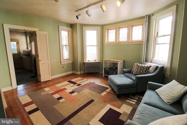 living area with radiator and dark wood-type flooring