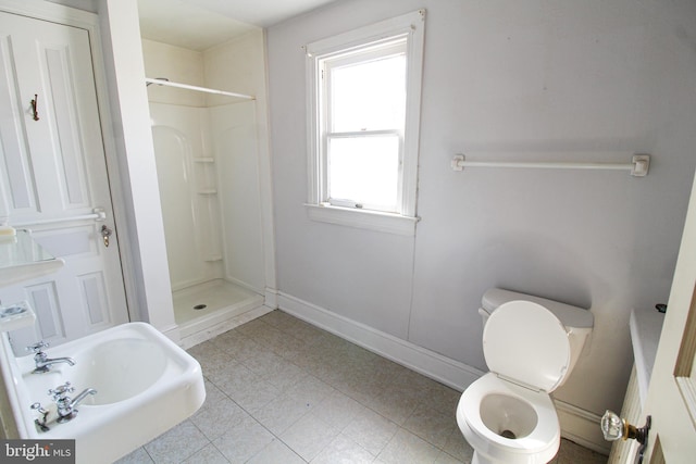 bathroom featuring toilet and a shower