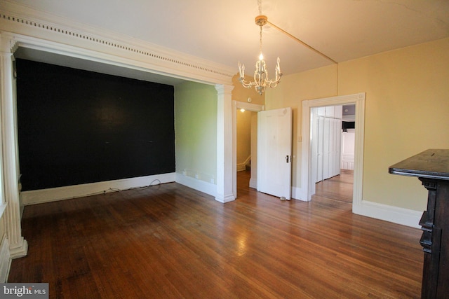 unfurnished dining area with dark wood-type flooring and a notable chandelier