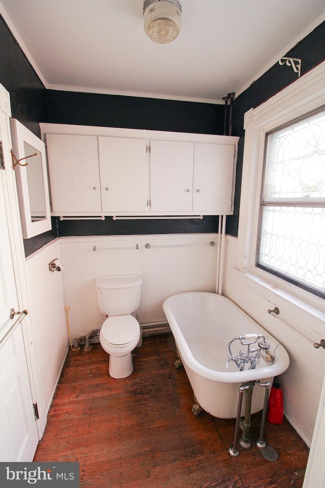 bathroom with wood-type flooring, toilet, and a bathing tub