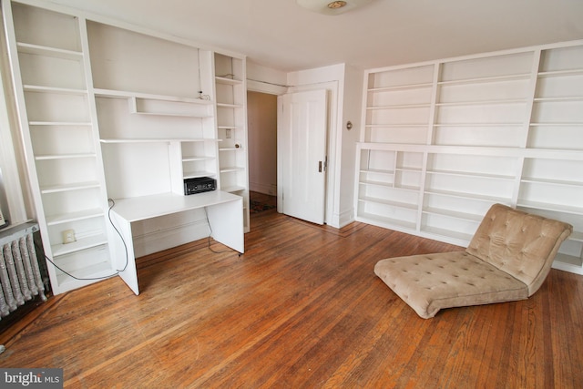 unfurnished room featuring radiator and dark hardwood / wood-style floors