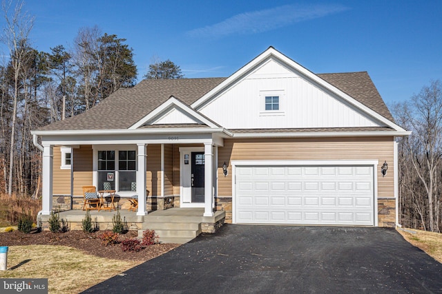 view of front of home with covered porch and a garage