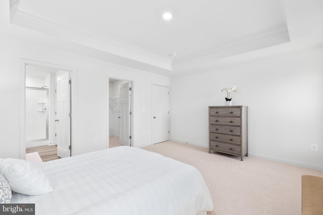 bedroom featuring light carpet, baseboards, a tray ceiling, crown molding, and recessed lighting